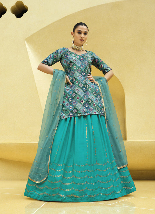 Vibrant Firozi Chinnon Silk Embellished Designer Lehenga Kameez